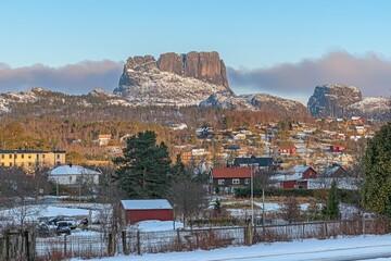 The first light of dawn illuminates the peak of Fugltinden in Troms, Norway.