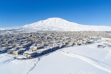 A snow-covered aerial shot of an old village in Hasroun, located in North Lebanon..An aerial perspective of a snowy old village in Hasroun, North Lebanon..From above, a snow-dusted old village
