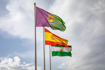 Flags of Spain, Andalusia and Malaga in the wind