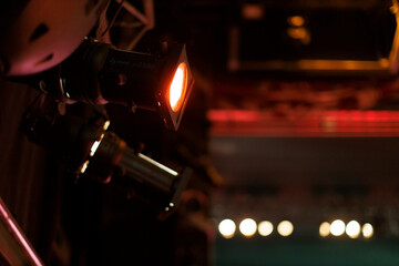 Stage lights illuminate a performance area in a theater during an evening event