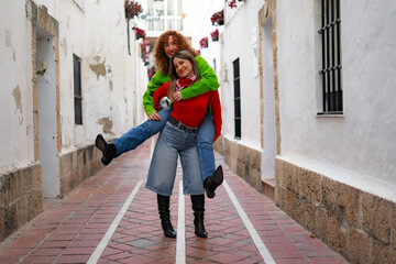two girls having fun happily in the middle of the street