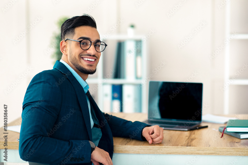 Aufkleber happy arab businessman sitting at table with laptop computer at company office, mockup for website d