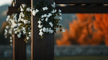 Flowers adorn a wooden trellis in a scenic landscape during autumn with vibrant fall colors