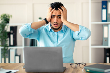 Desperate Arab businessman having too much work, making mistake, cannot meet deadline, suffering...