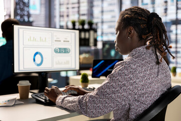 Businesswoman analyzing performance metrics on her computer at the workplace, office life. Engaged...