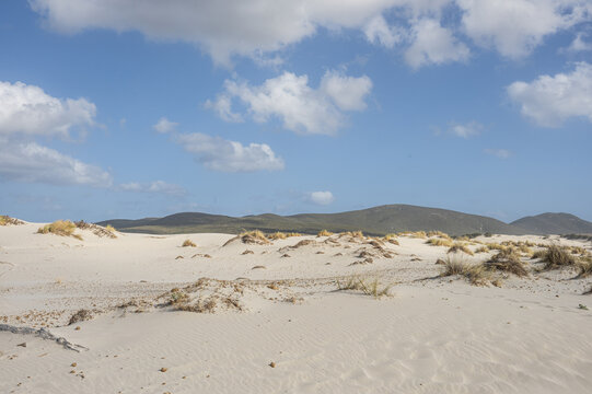 The beautiful beach of Is Solinas in Sardinia with its high white dunes on a windy day