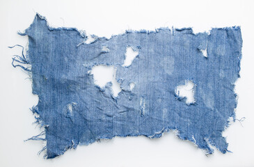 jeans. a frayed and torn piece of denim rag