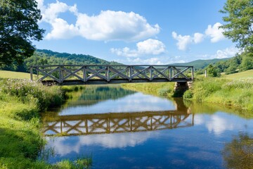 Obraz premium Rustic bridge, calm river, green hills, sunny day, idyllic scene
