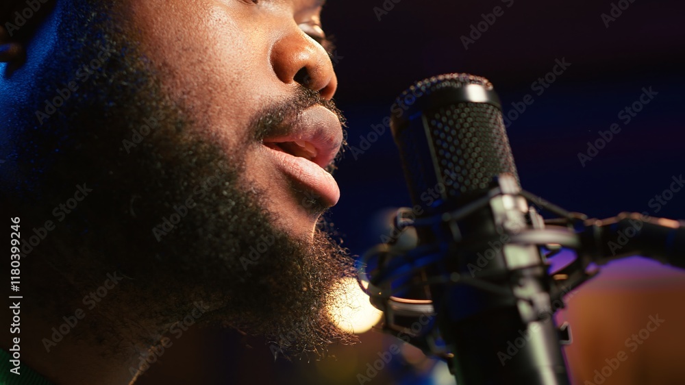 Aufkleber artist records his voice on microphone in home studio singing a song composed by him. skilled musici