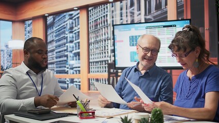 Senior people in a meeting with a financial advisor discussing about retirement plans, securing...