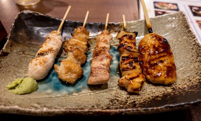 A detailed close up of meat skewers with Wasabi in Japan. 