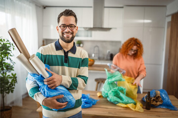 Portrait of man with plastic blue bag recycle at home kitchen