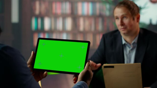 Diverse secret agents examine clues at CIA secret base with a green screen, working on surveillance systems and collecting data to help on mission. Drinking whiskey at the classy library. Camera B.