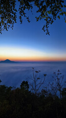 Breathtaking sunrise over misty mountains and trees