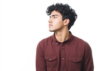Fototapeta premium Serious young Hispanic man gazing aside against a white background