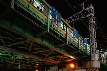Train on elevated railway at night in Ichigaya, Japan
