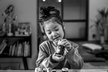 Little girl playing with Matryoshka