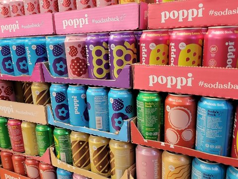 Poppi Prebiotic Soda 4g sugar - 12 Fl Oz 355ml cans in Key Food store in Queens, NY, USA: raspberry rose, strawberry, wild berry, lemon lime, root beer, classic cola. Photo by Artist Nadia Russ.