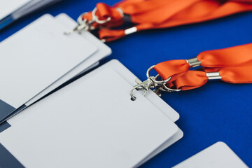 Process of checking in on conference congress forum event, registration desk table, visitors and attendees receiving lanyard with name badge and entry wristband bracelet and register electronic ticket