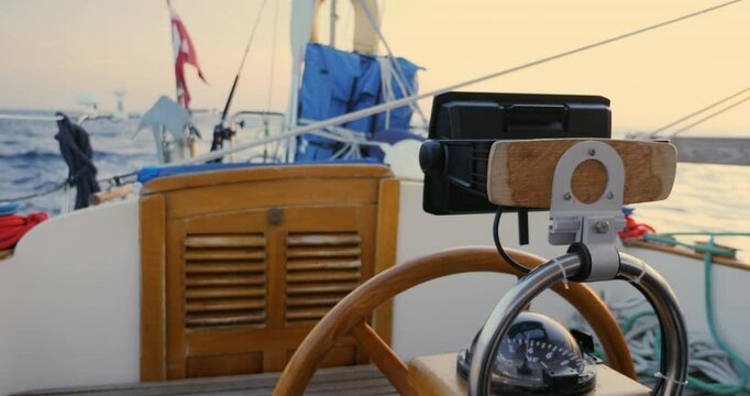 View of rudder and cockpit on a sailboat steered by an electric autopilot while crossing the Bay of Biscay