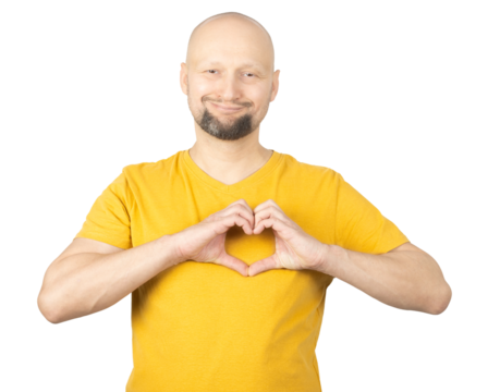 Smiling Man in Yellow Shirt Making Heart Shape with Hands