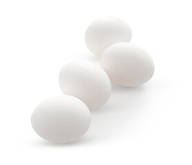 White chicken eggs isolated on light background