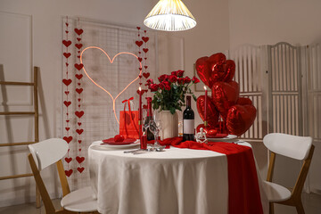 Table setting for Valentine's Day with roses in dining room
