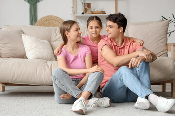 Obraz premium Cute girl hugging her parents with medical patches after vaccination at home
