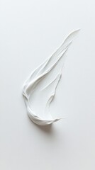 White cream smear abstract shape on white surface.