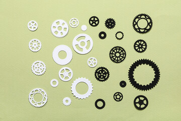 Different paper gears on green background