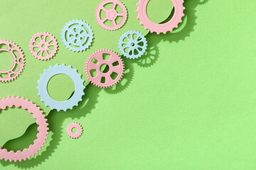 Different paper gears on green background