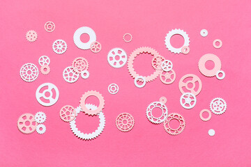 Different paper gears on pink background