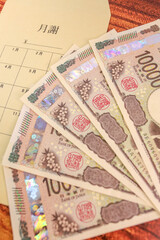 新紙幣一万円札と月謝袋