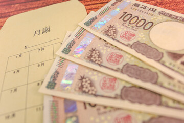 新紙幣一万円札と月謝袋