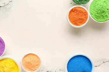 Composition with bowls of different color powder pigments on light background