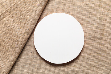 Blank round card on burlap fabric