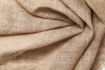 Fototapeta premium Burlap fabric with folds, closeup