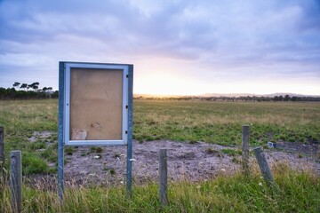Old wooden notice board in a field