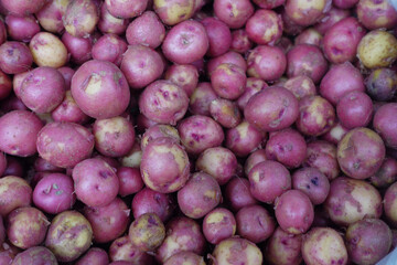 A vibrant display of Fresh Red Potatoes showcased beautifully in the market