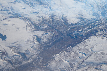 A Stunning Aerial View of a SnowCovered Landscape Featuring Mountain Ranges
