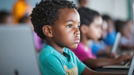 Young students demonstrate concentration and engagement while using laptops for educational activities in a dynamic classroom setting
