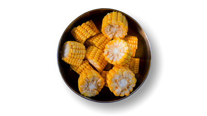 Close-up shot of a fresh corn in a metal bowl over an isolated white background. Top view.