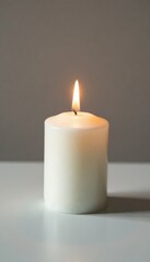 Unlit white wax candle on a plain surface with soft lighting, light, surface, candle