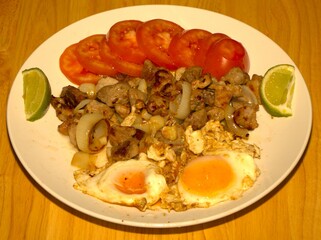 fried pork dough with onion in lard served with tomato salad two and fried eggs with salt and extra virgen olive oil.