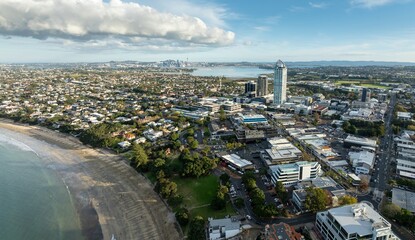High-angle view of Auckland, New Zealand, showcasing city center, beach, and residential areas....