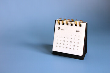 Monthly calendar template for the new year 2025 desk calendar,isolated on Blue background.