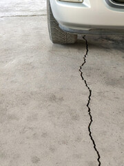 Crack in the concrete surface of the parking area
