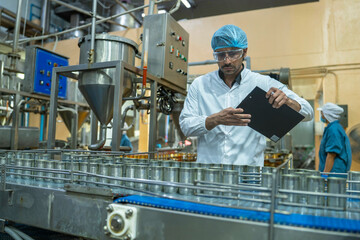 Technician performing detailed quality checks on a manufacturing line, highlighting industrial innovation, efficiency, and a commitment to high production standards.