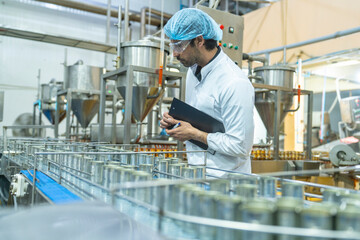 Professional closely examining production materials on a conveyor system, representing dedication...
