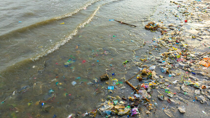 Top view trash, plastic cups and plastic bags at the beach. environmental problem concept and...